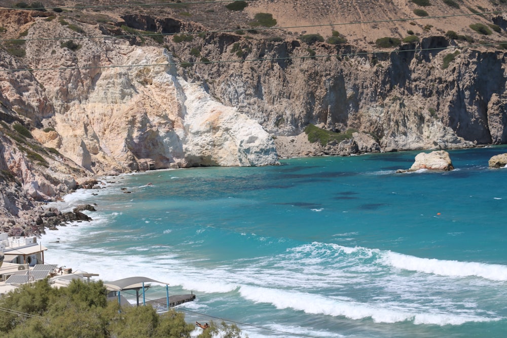 a view of a beach with a cliff in the background