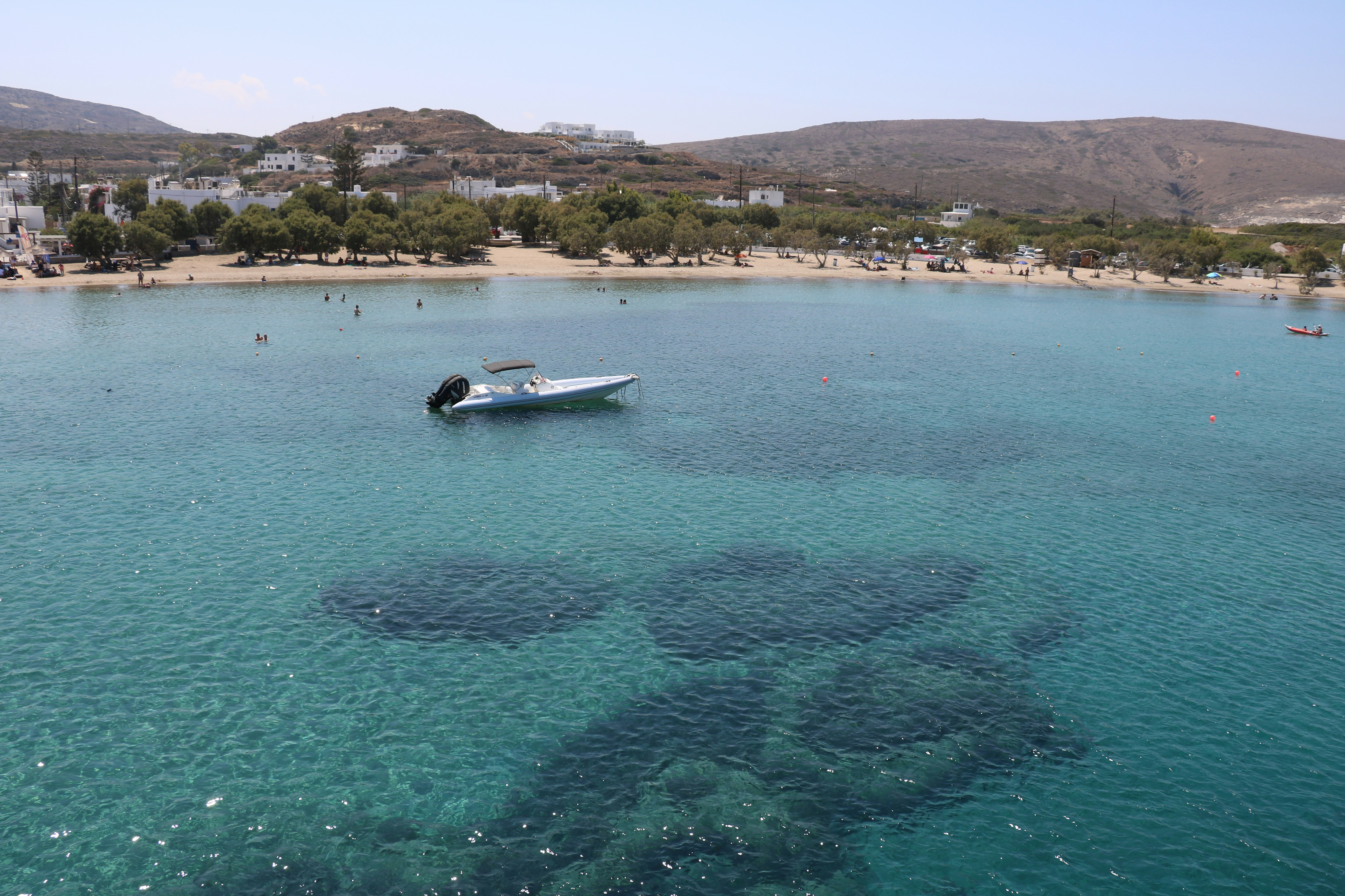 a boat floating on top of a body of water, Greece, Summer 2023