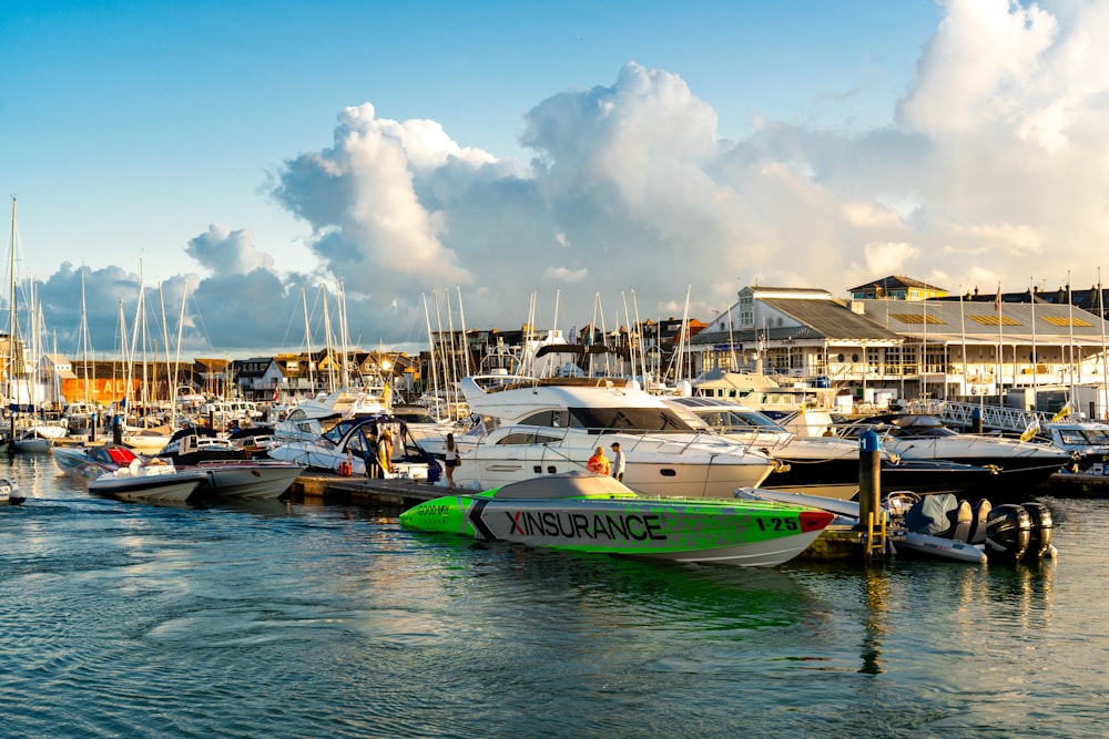 a marina filled with lots of boats under a cloudy blue sky