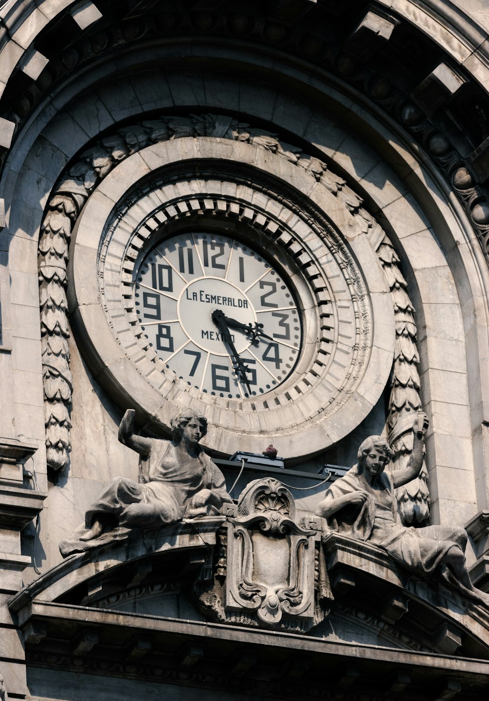 a large clock mounted to the side of a building