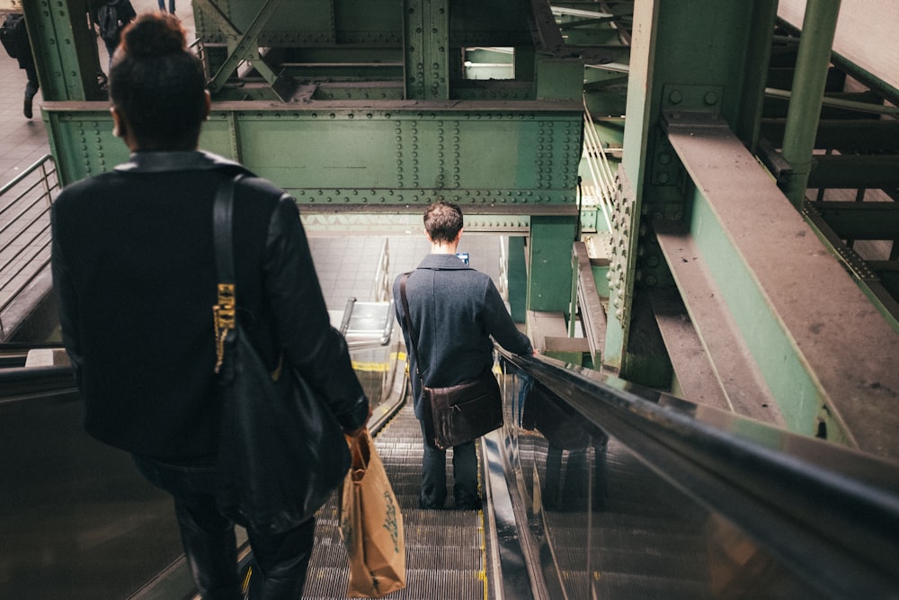 a couple of people that are walking down a set of stairs