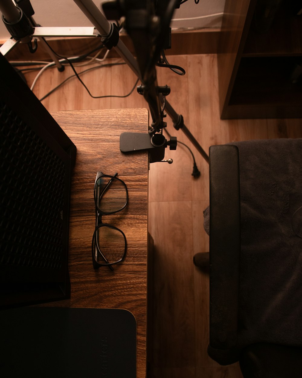 a room with a desk and a chair and a television