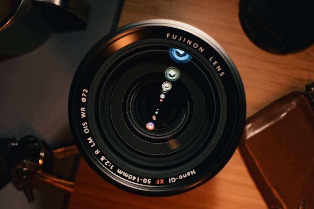a camera lens sitting on top of a wooden table