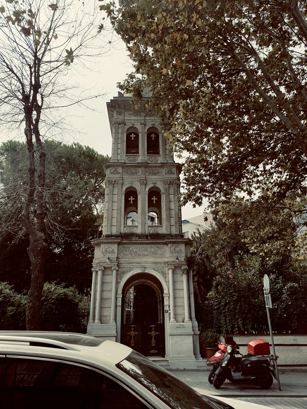 a motorcycle parked in front of a clock tower