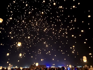 An ethereal setting with floating lanterns illuminating a peaceful gathering.