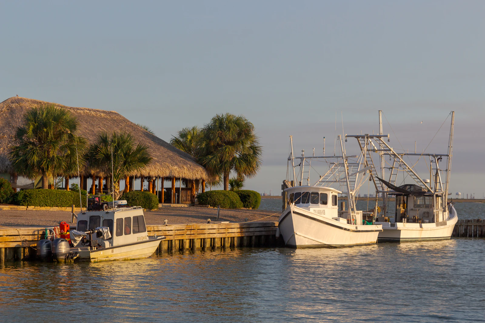 Small boats moored along a lake dock.
