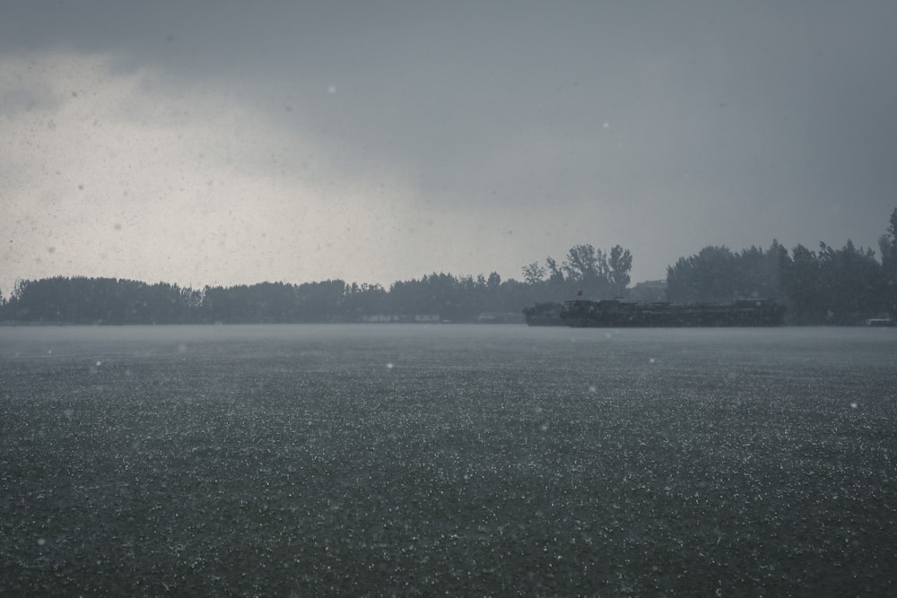 a large body of water with a boat in the distance