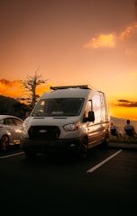 A comfortable wheelchair-accessible van parked outside a healthcare facility at sunset.