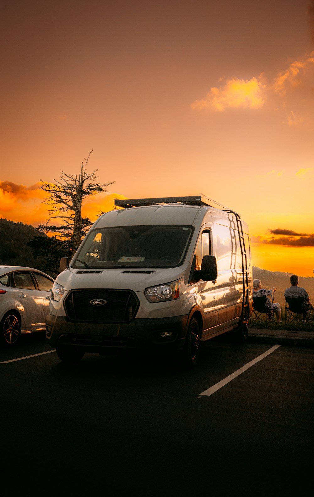 a van is parked in a parking lot at sunset