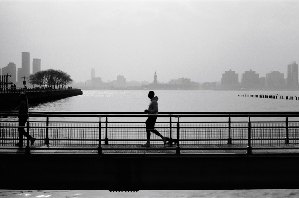 a person walking on a bridge over a body of water