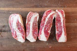 Close-up of expertly cut premium British beef displayed on a wooden board.