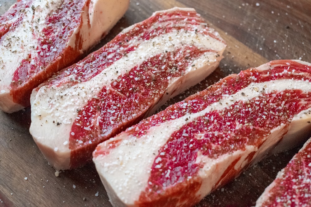 a close up of raw meat on a cutting board