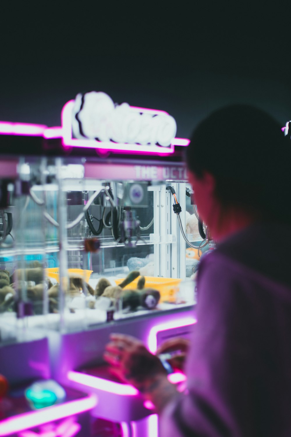 a woman standing in front of a vending machine