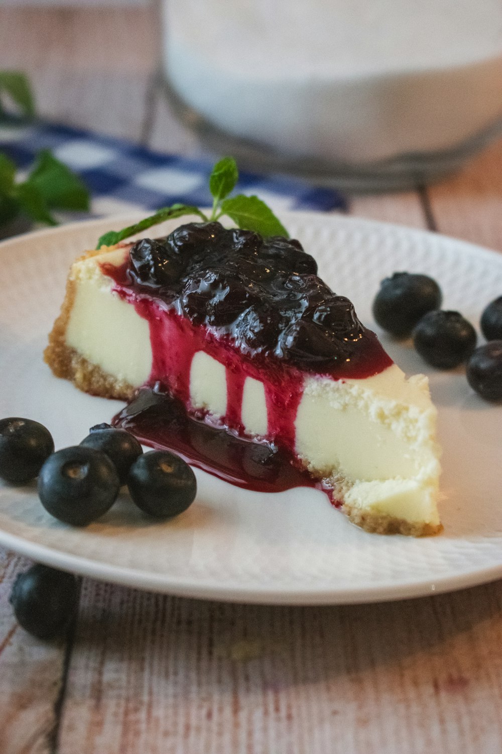 a piece of cheesecake with blueberries on a plate