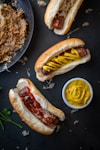 a couple of hot dogs sitting on top of a table