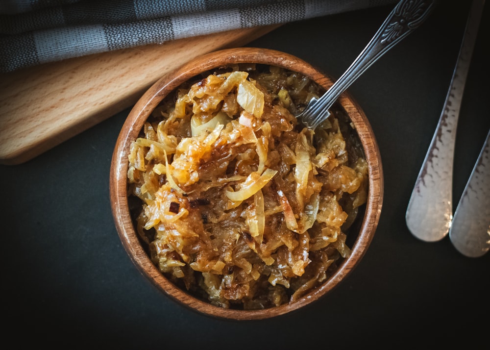 a bowl of food with a spoon next to it