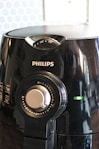 a close up of a black blender on a table