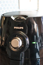 a close up of a black blender on a table
