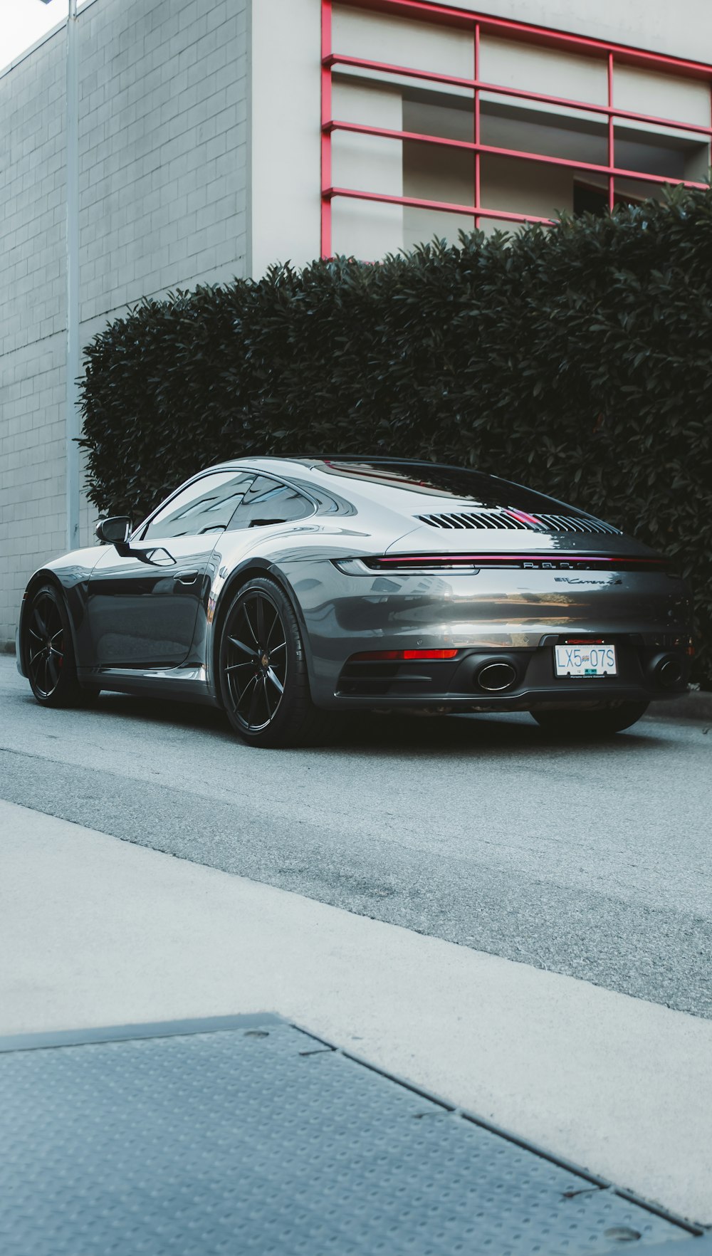 a grey sports car parked on the side of the road