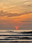 A stunning sunset over the horizon from a boat.