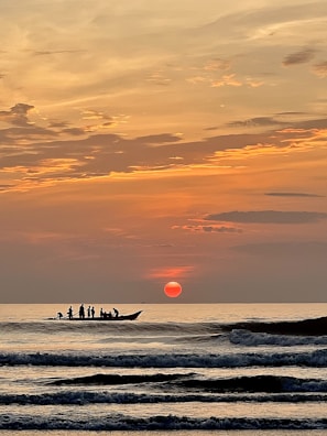 A stunning sunset over the horizon from a boat.