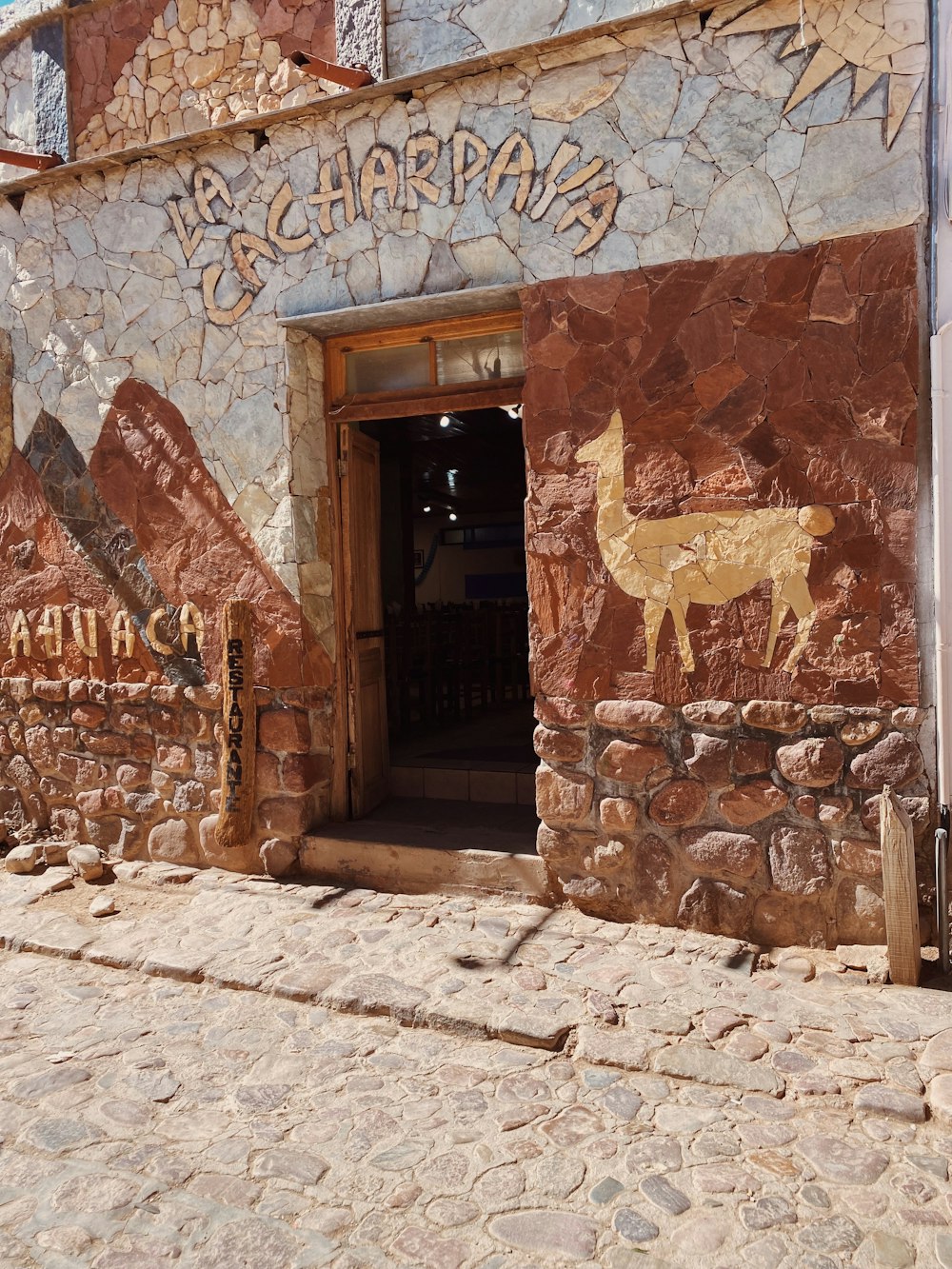 a stone building with a painting of a deer on it