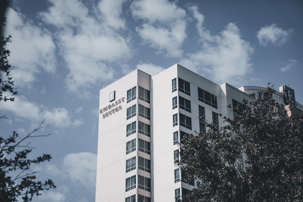 a tall white building with a sky background