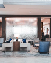 Elegant hotel lobby featuring rich dark tones and stylish seating.