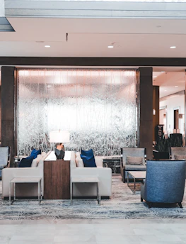 Elegant hotel lobby featuring rich dark tones and stylish seating.
