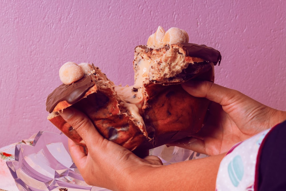 a person is holding a half eaten pastry