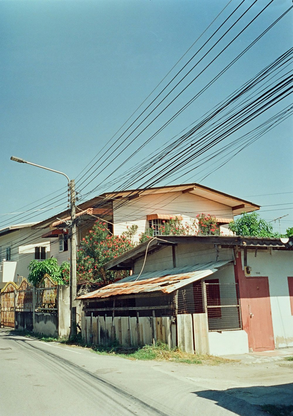 a street with a building and power lines above it