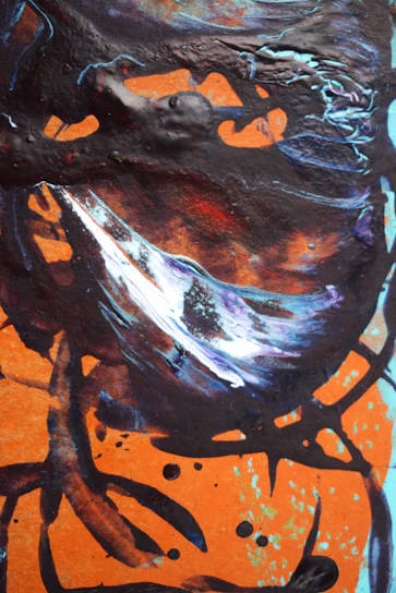 A vibrant abstract painting with swirling oranges, blues, and greens accented by bold black strokes.