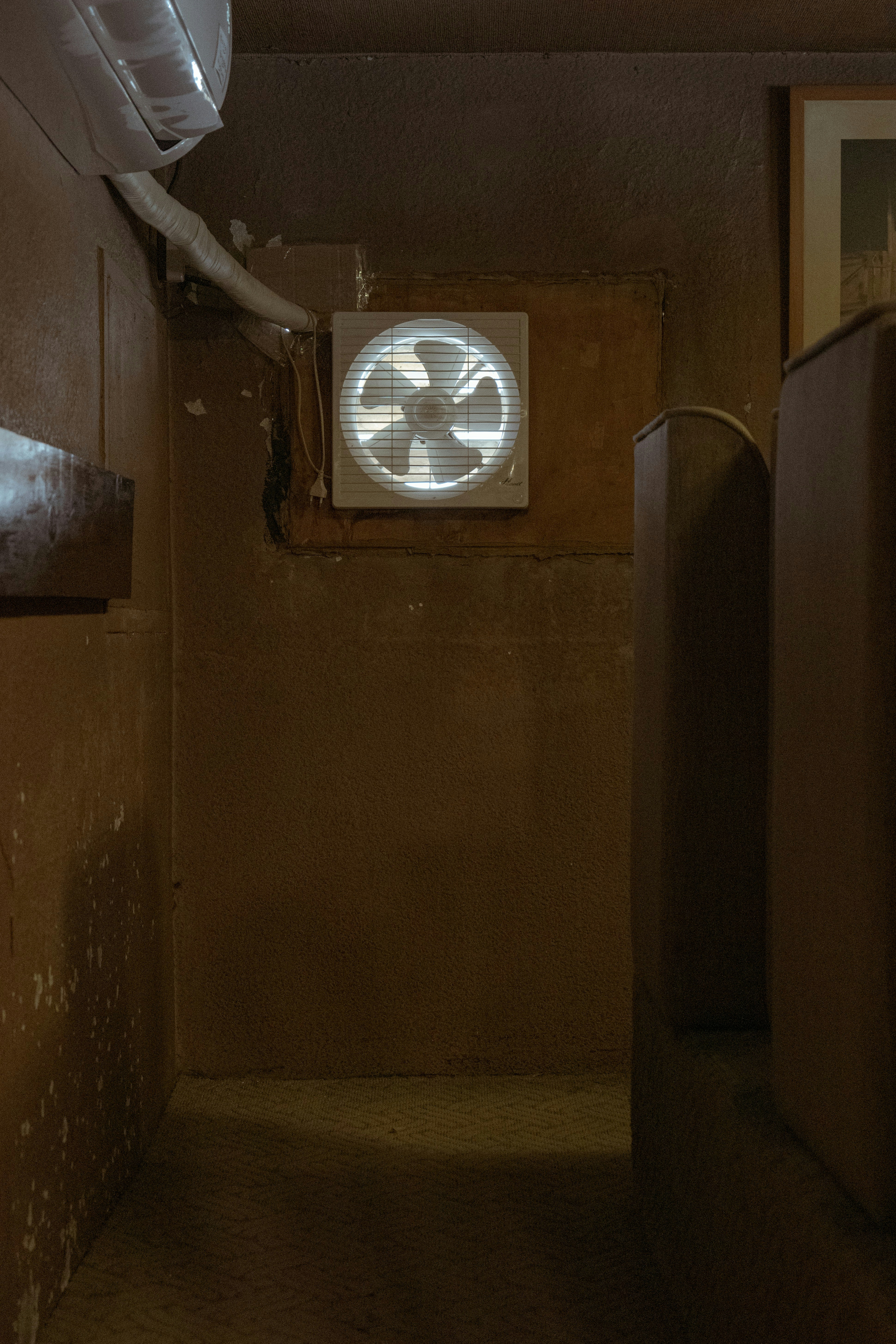 a room with a fan on the wall