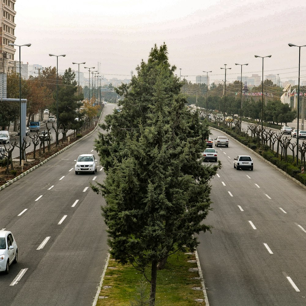 a street filled with lots of traffic next to tall buildings