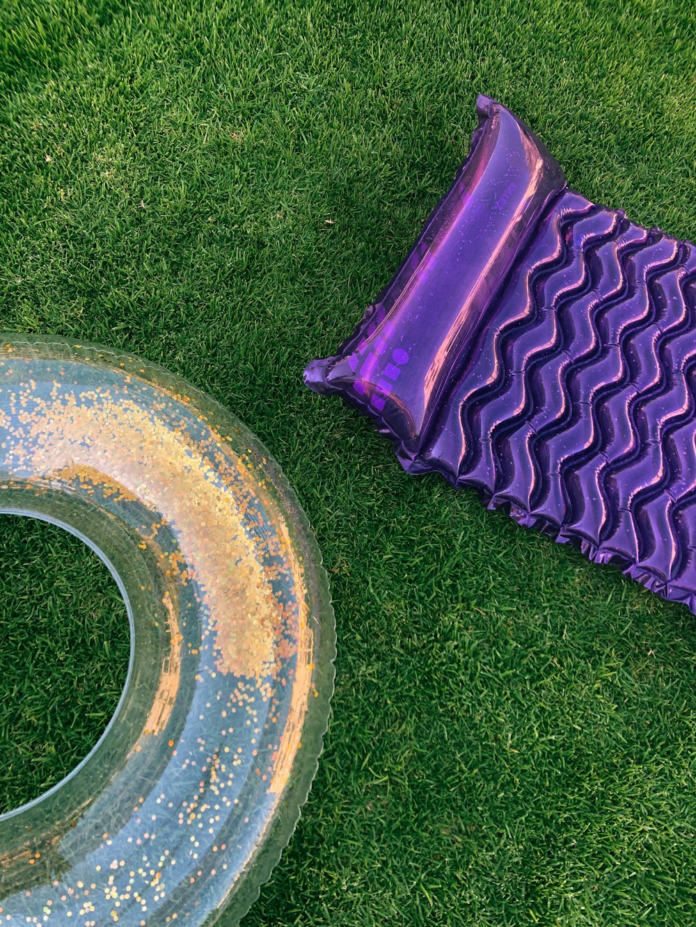 a purple mat and a tire laying on the grass