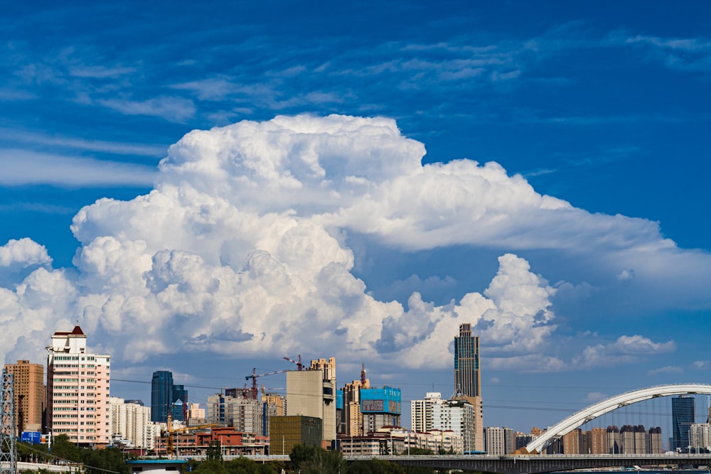 a large cloud is in the sky over a city