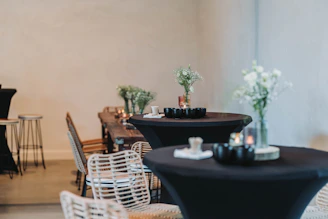 A minimalistic Scandinavian-style restaurant interior with candlelit tables and a photographer capturing dishes.