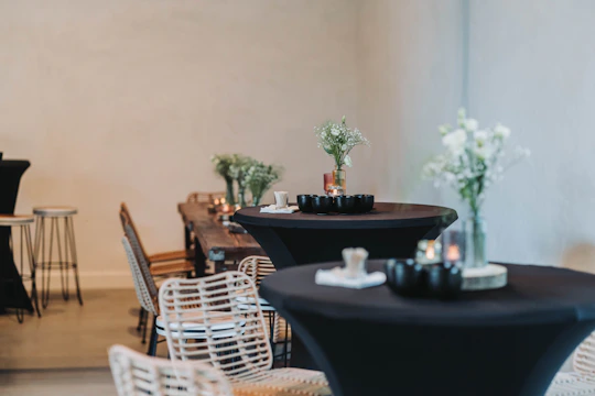 A minimalistic Scandinavian-style restaurant interior with candlelit tables and a photographer capturing dishes.