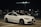 a white car parked in a parking lot at night