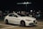 a white car parked in a parking lot at night