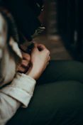 Close-up of hands in a gentle mindfulness pose on a soft blanket