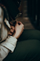 Close-up of hands resting gently on knees during a quiet meditation practice.