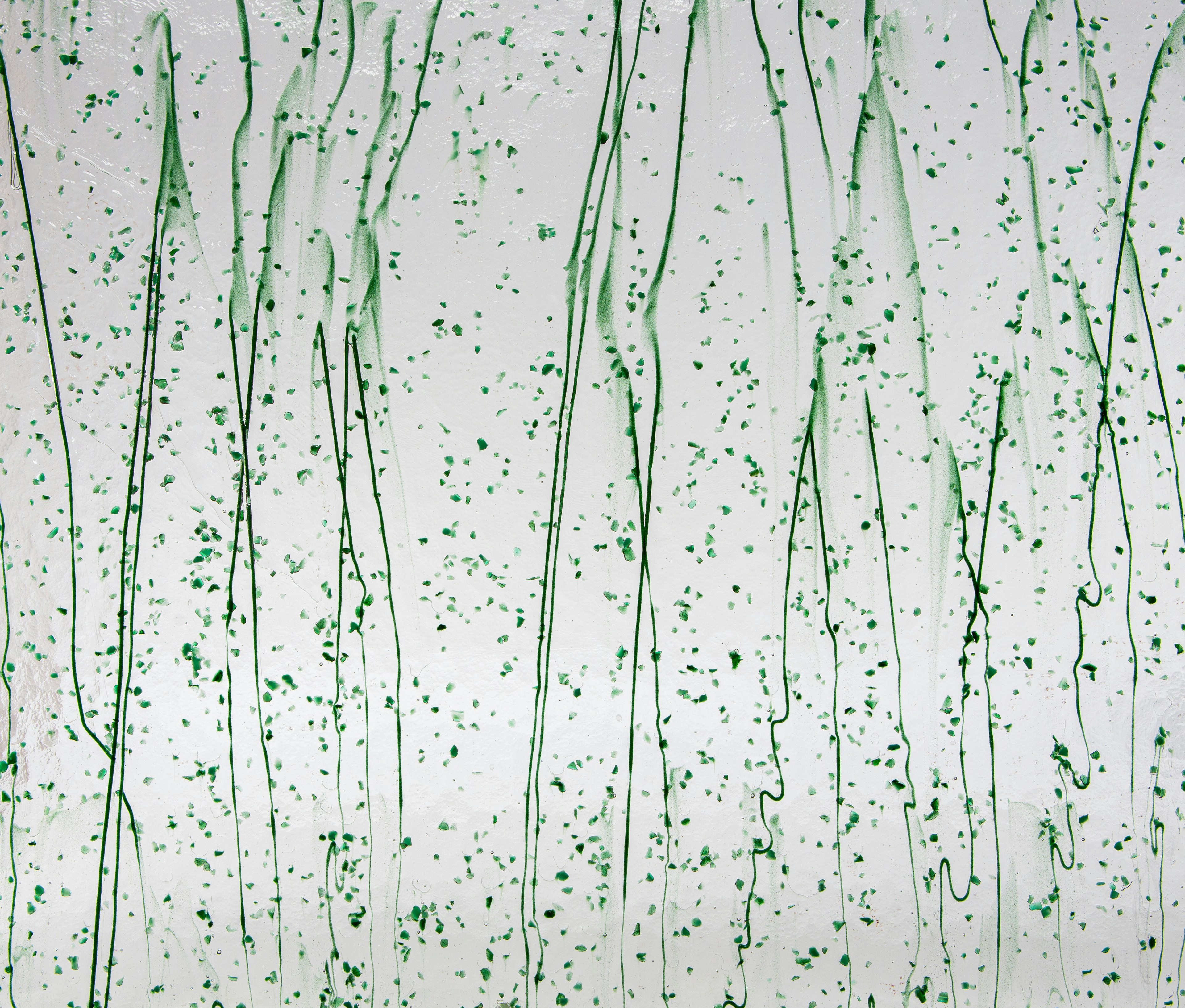 a painting of green sprinkles on a white wall