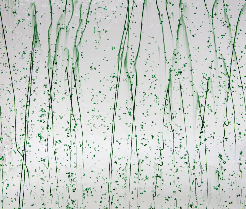 a painting of green sprinkles on a white wall