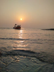 Couple enjoying a private boat ride at sunset with calm sea around