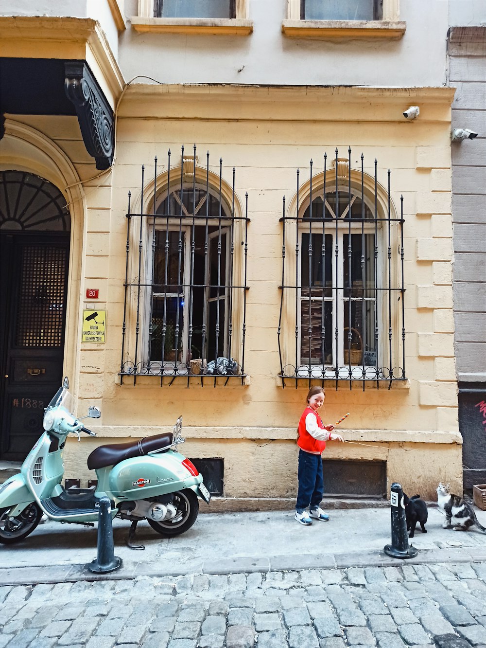 a young boy standing in front of a building