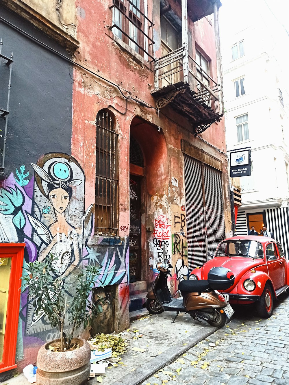 a red car parked in front of a building