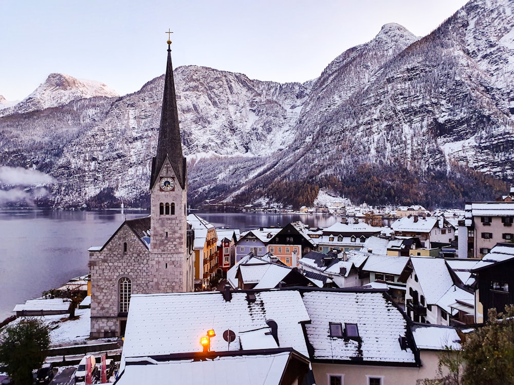 a church in the middle of a town with mountains in the background