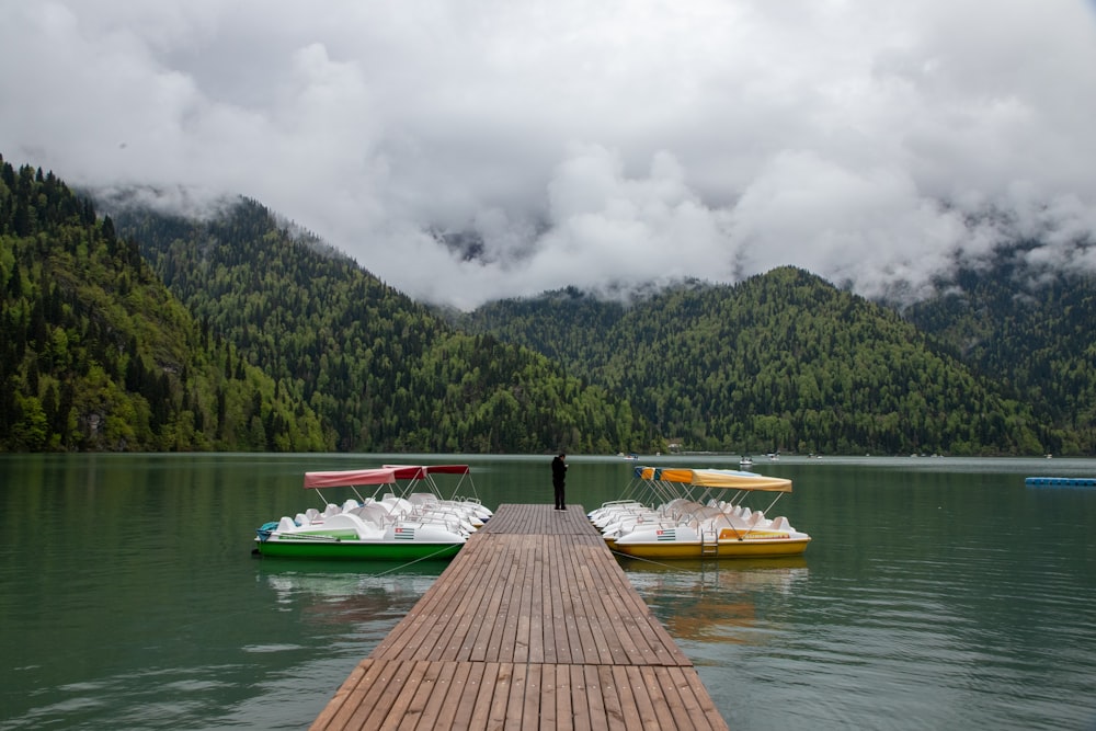 uma doca em um lago com vários barcos na água