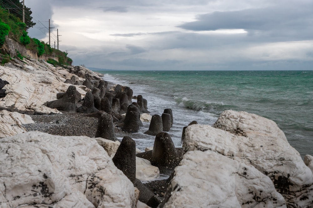 a rocky beach with large rocks on the shore